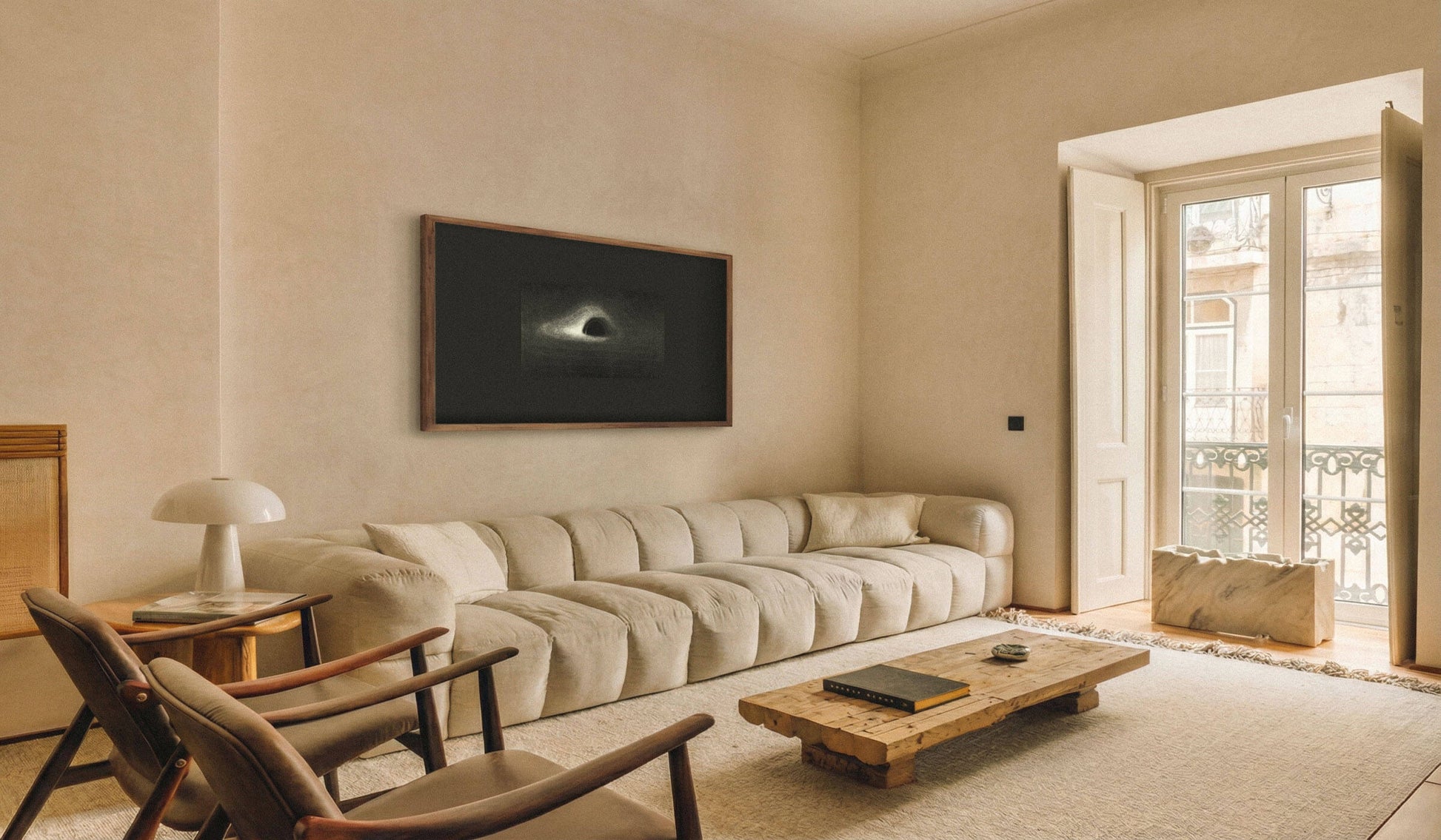Living room featuring a framed artwork of Black Hole, 1979 above a comfortable sofa.